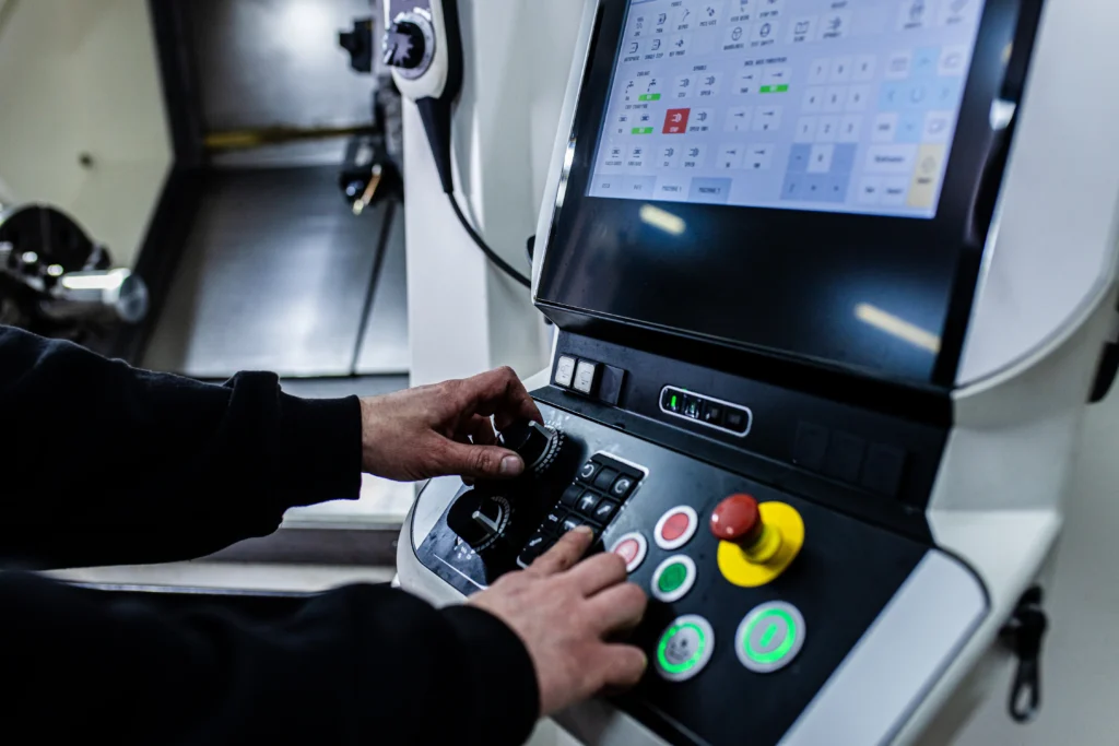 An experienced worker operating a CNC lathe.